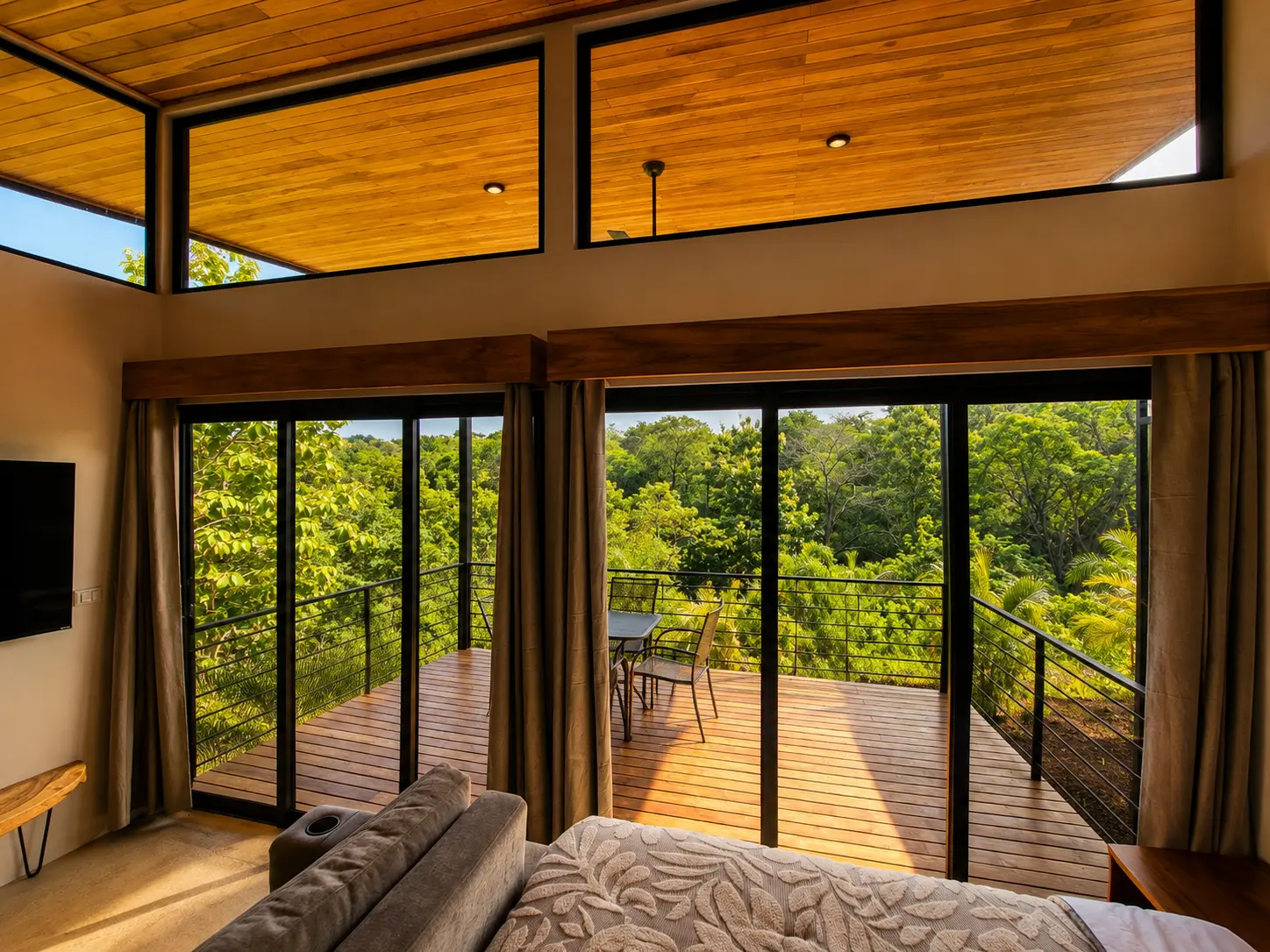 Sliding glass doors opening onto the private teak deck at golden hour