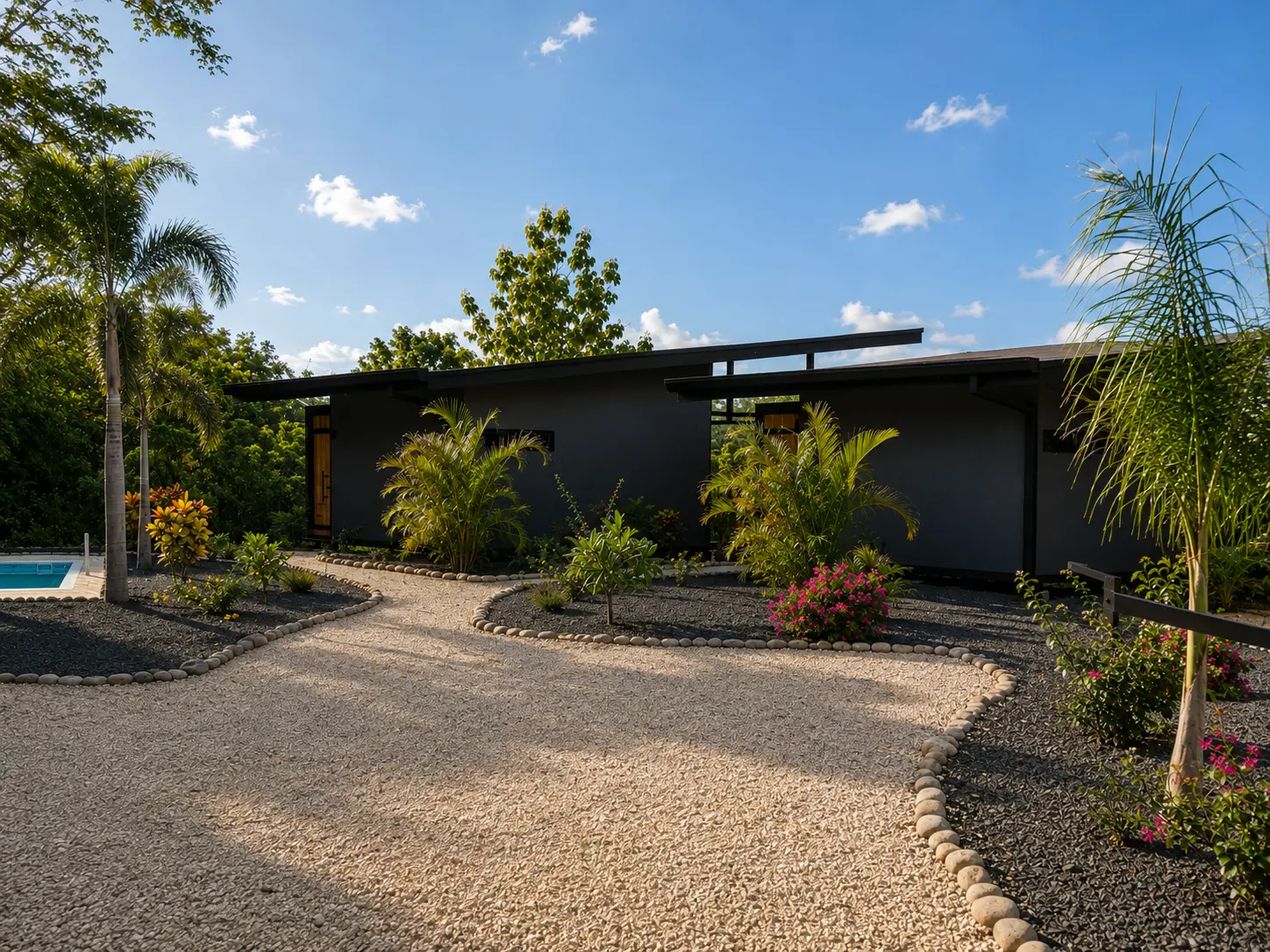 Gravel path leading to the bungalows with tropical gardens