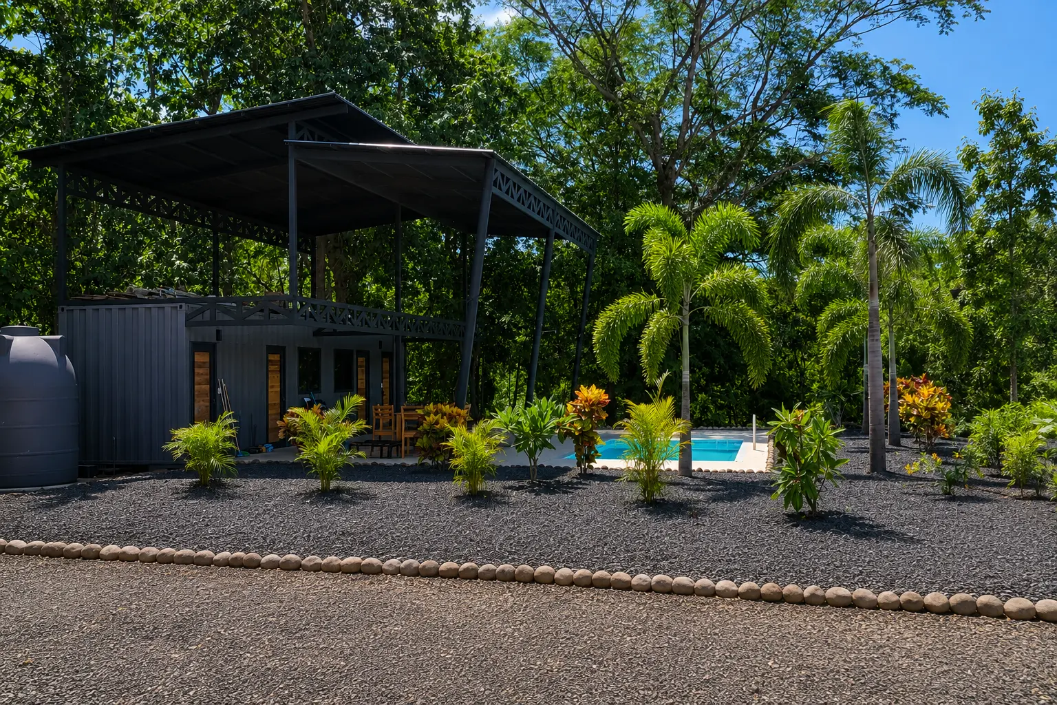 Covered ranch and pool surrounded by palms